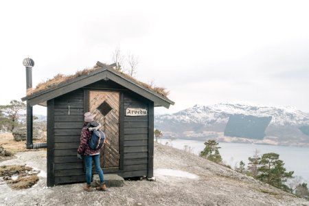 Person Standing In Front Of Black Shed photo