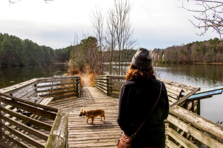 Woman Walking On Dock With Dog photo