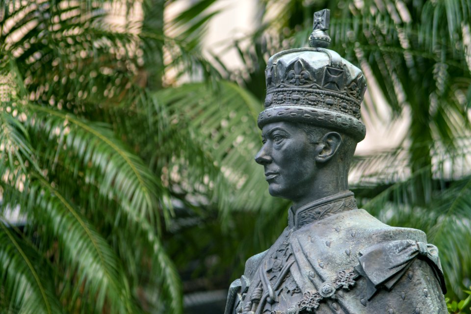 Male Statue Near Green Palm Trees At Daytime