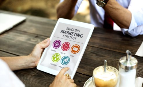 Person Holding Inbound Marketing Strategy Book photo
