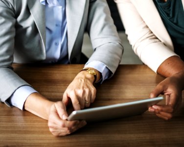 Two Person Using Gray Tablet photo