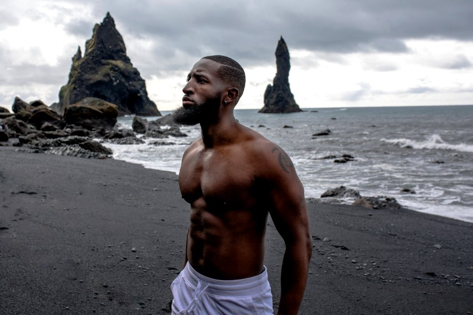 Man Wearing White Bottoms Near Body Of Water photo