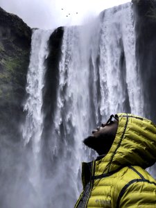 Photography Of Man Wearing Bubble Hoodie Jacket Near Waterfalls photo