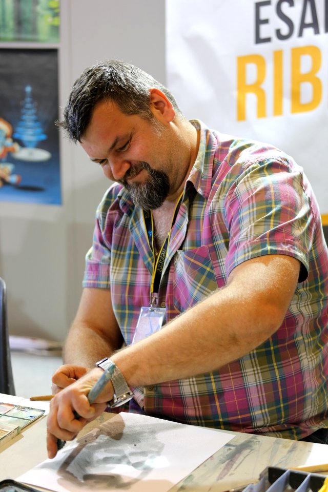 Man Wearing Pink Checkered Shirt While Sketching photo