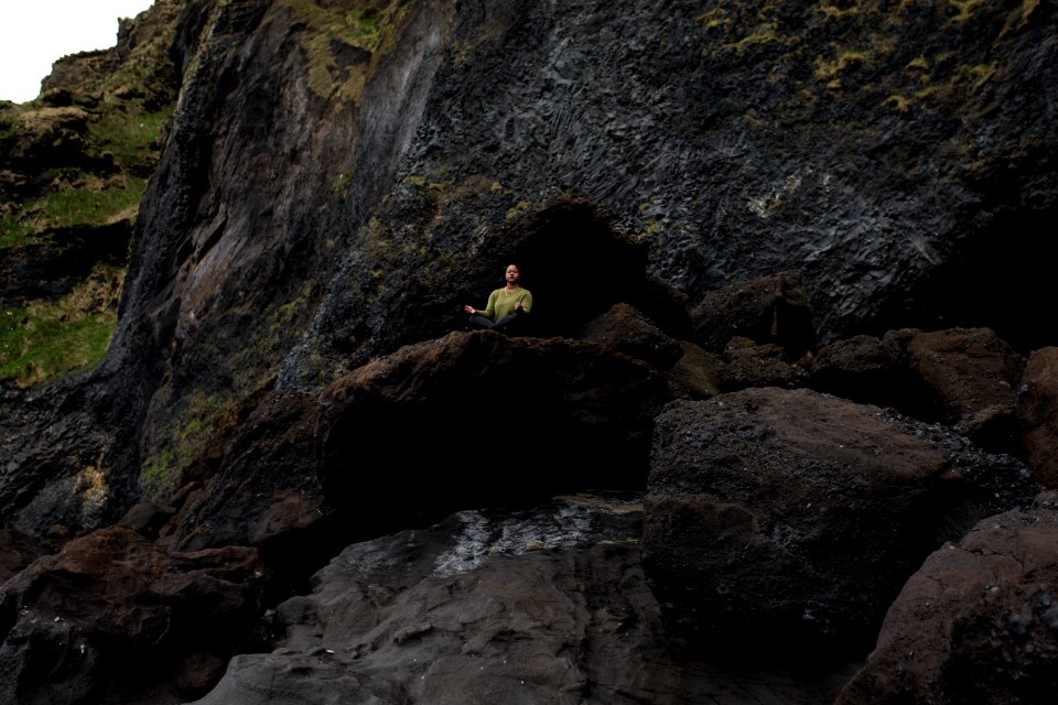 Photo Of Person Meditating On Top Of Rock