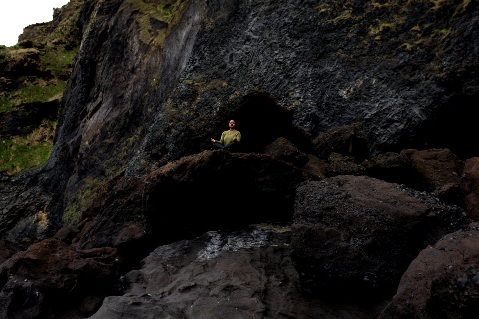 Photo Of Person Meditating On Top Of Rock photo