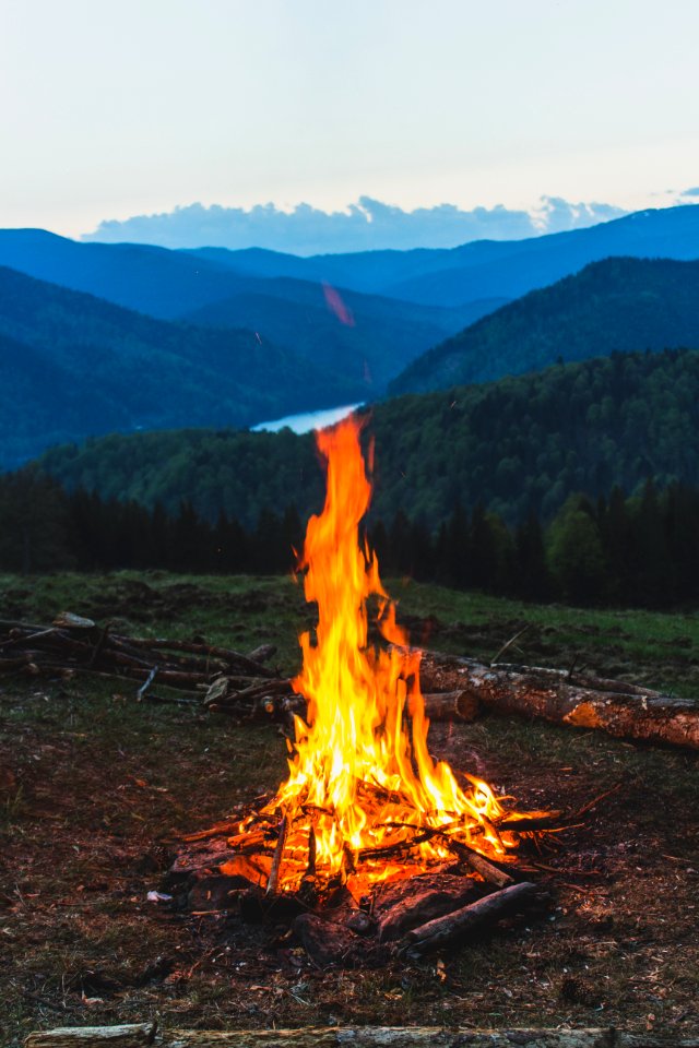 Bonfire Near Grass Field During Dawn