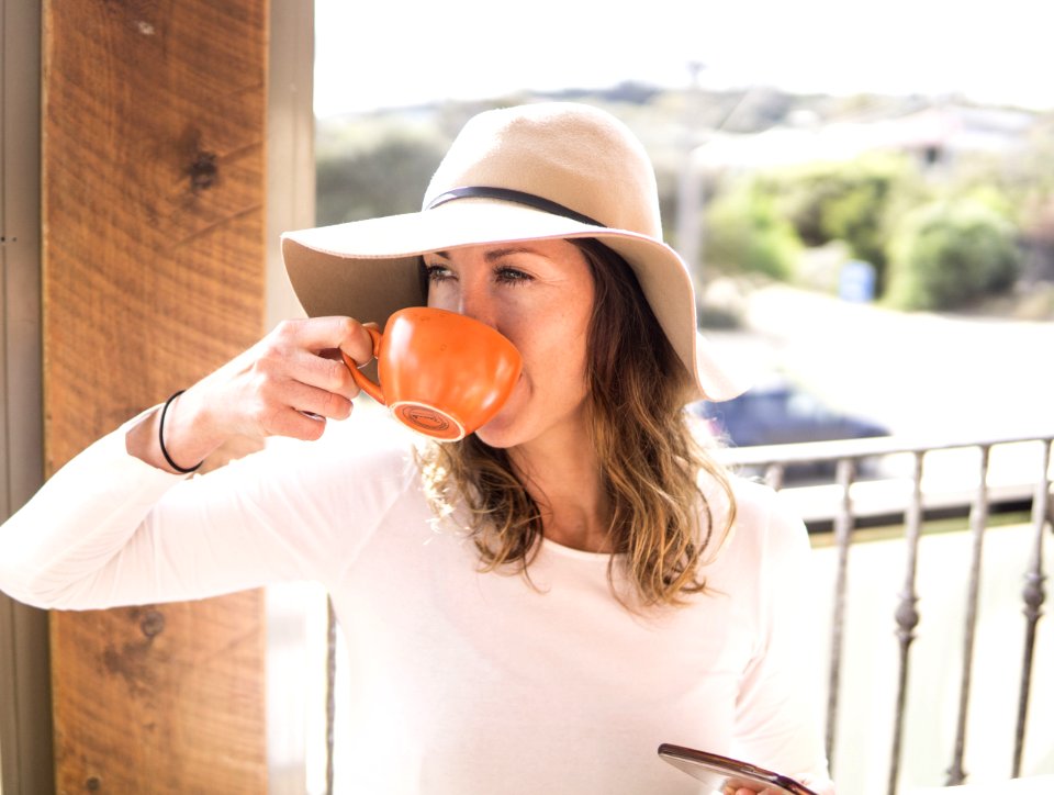 Woman Wearing Hat Holding Mug