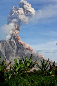 Erupting Volcano Under Blue Sunny Cloudy Sky