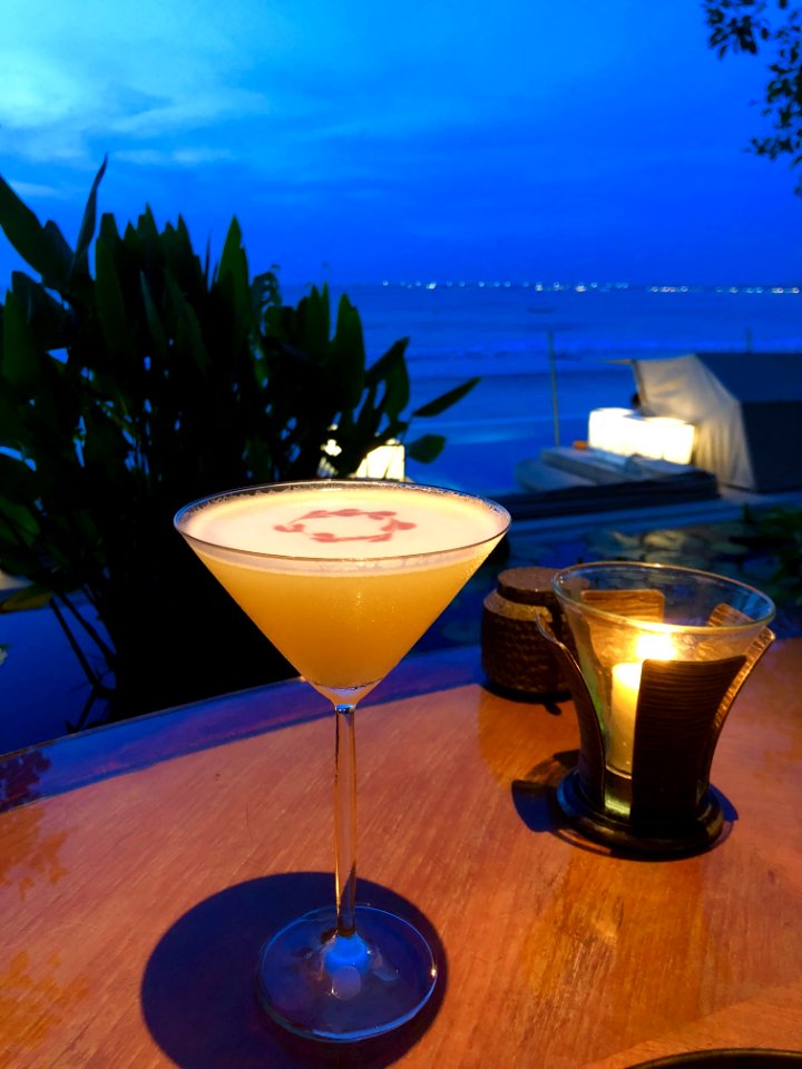 Orange Liquid In Clear Martini Glass On Brown Wooden Surface