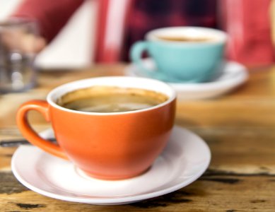 Shallow Focus Photo Of Orange Ceramic Mug On White Saucer photo