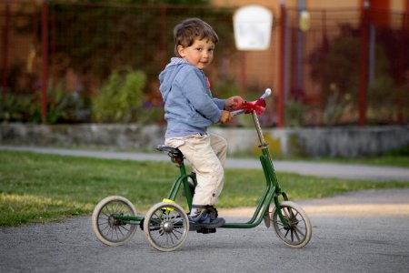 Boy Riding Green Bike photo