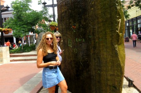 Women Standing Near Brown Monolith photo