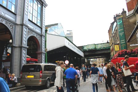 People On Gray Road Surrounded By Buildings