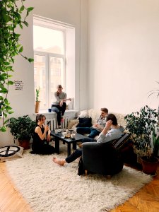 People Gathered Inside House Sitting On Sofa