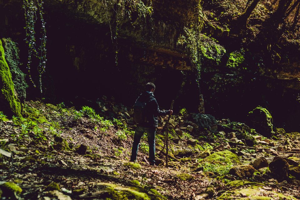 Man In Blue Jacket And Jeans Holding Stick