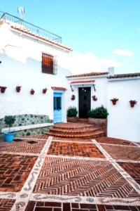 White Concrete House With Brown Tiled Yard photo