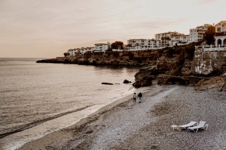 Two Person Walking On Seashore photo