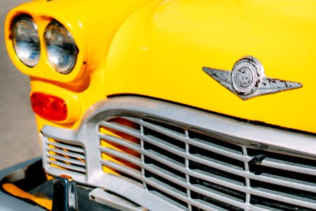 Closeup Photograph Of Yellow Car Grille