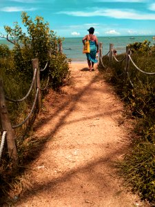 Woman Wearing Blue Scarf Walking On Pathway