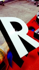 Person Holding White R Marquee photo