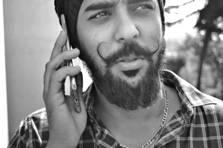 Grayscale Portrait Photo Of Man Holding Phone photo