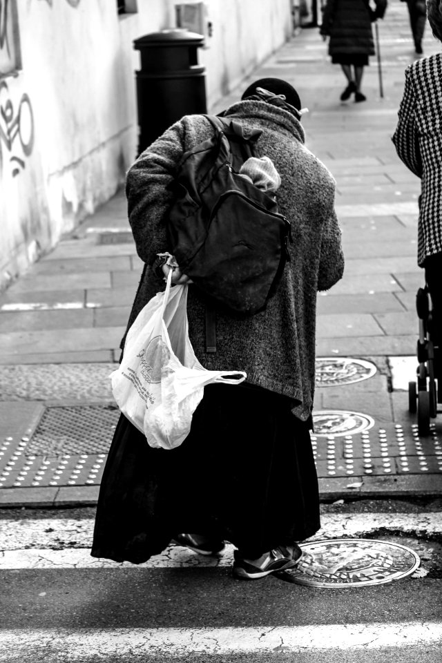 Man Holding Plastic Bag With Coat