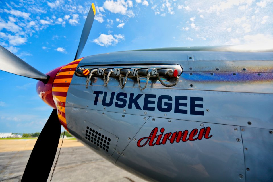 Gray Tuskegee Airmen Airplane Under Blue And White Cloudy Skies At Daytime photo