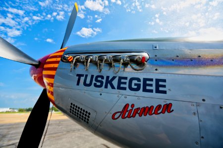 Gray Tuskegee Airmen Airplane Under Blue And White Cloudy Skies At Daytime photo