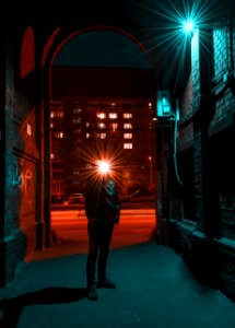 Photo Of Man In Jacket Standing In Alley photo