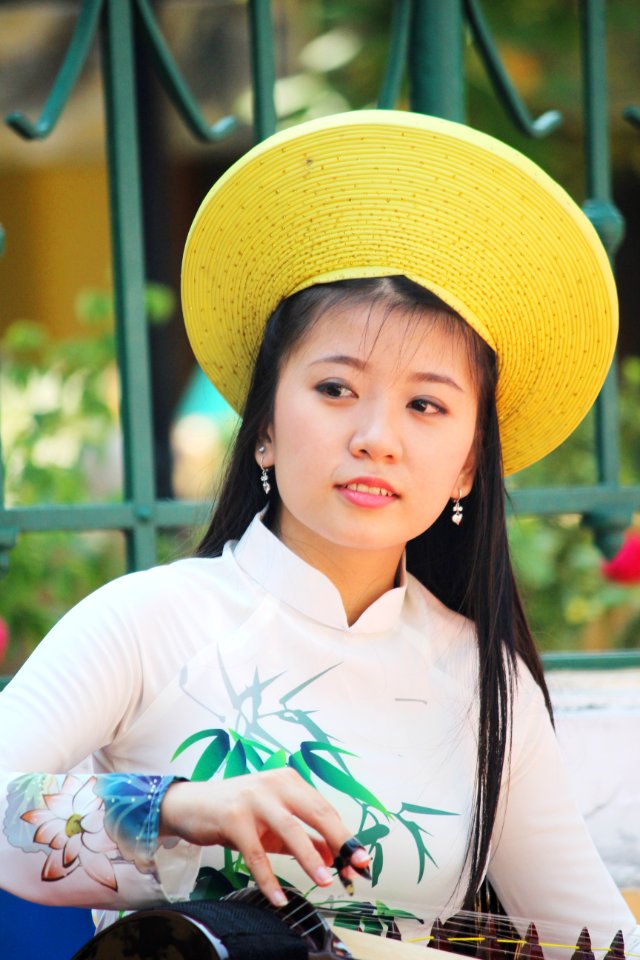 Woman In Beige Green And Pink Floral Long-sleeved Top With Yellow Hat