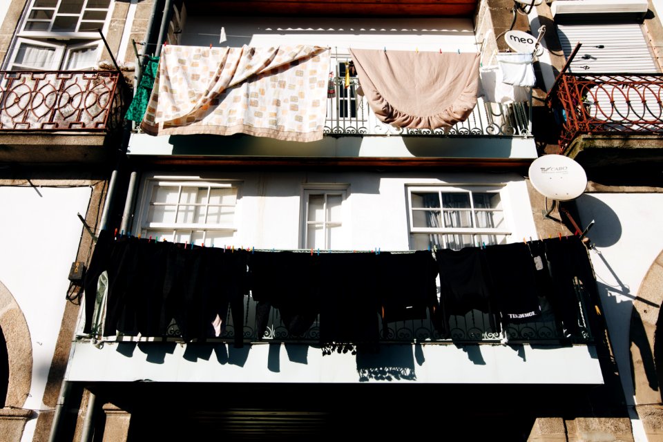 Close Up Photo Of Black Clothes Hanged Outside Window