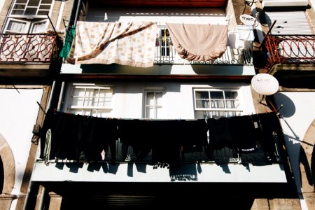 Close Up Photo Of Black Clothes Hanged Outside Window