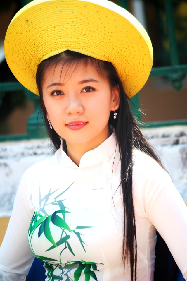 Woman Wearing White Long-sleeved Shirt And Yellow Hat photo