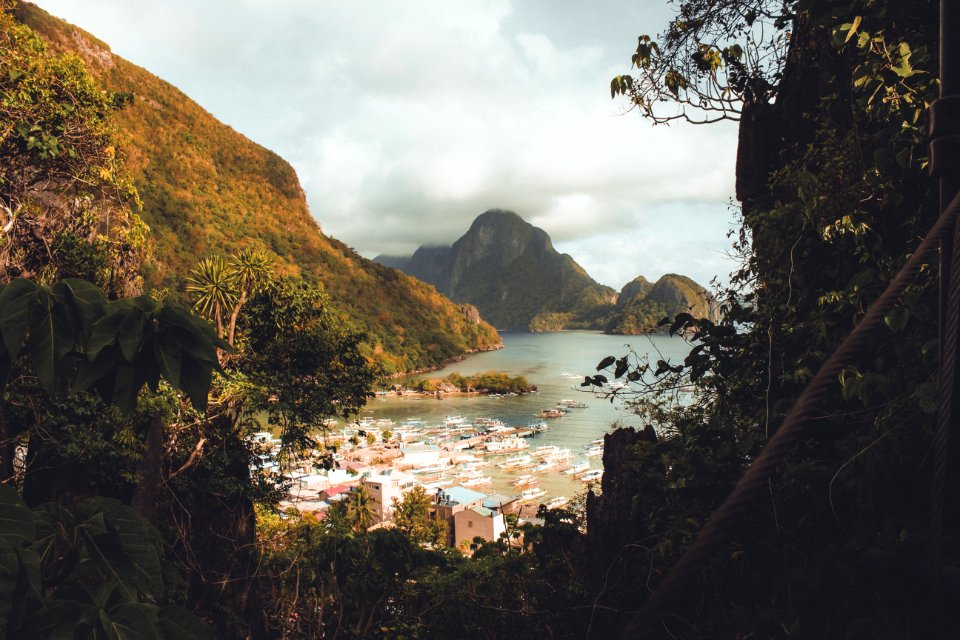 Houses Near Body Of Water Surrounded By Moutnains photo