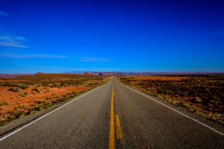 Straight Road Surrounded With Grass photo