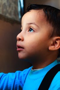 Boy Wearing Blue Top Looking Up photo