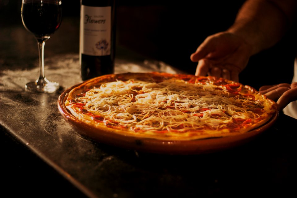 Person Holding Pepperoni Pizza On Tray