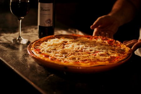 Person Holding Pepperoni Pizza On Tray