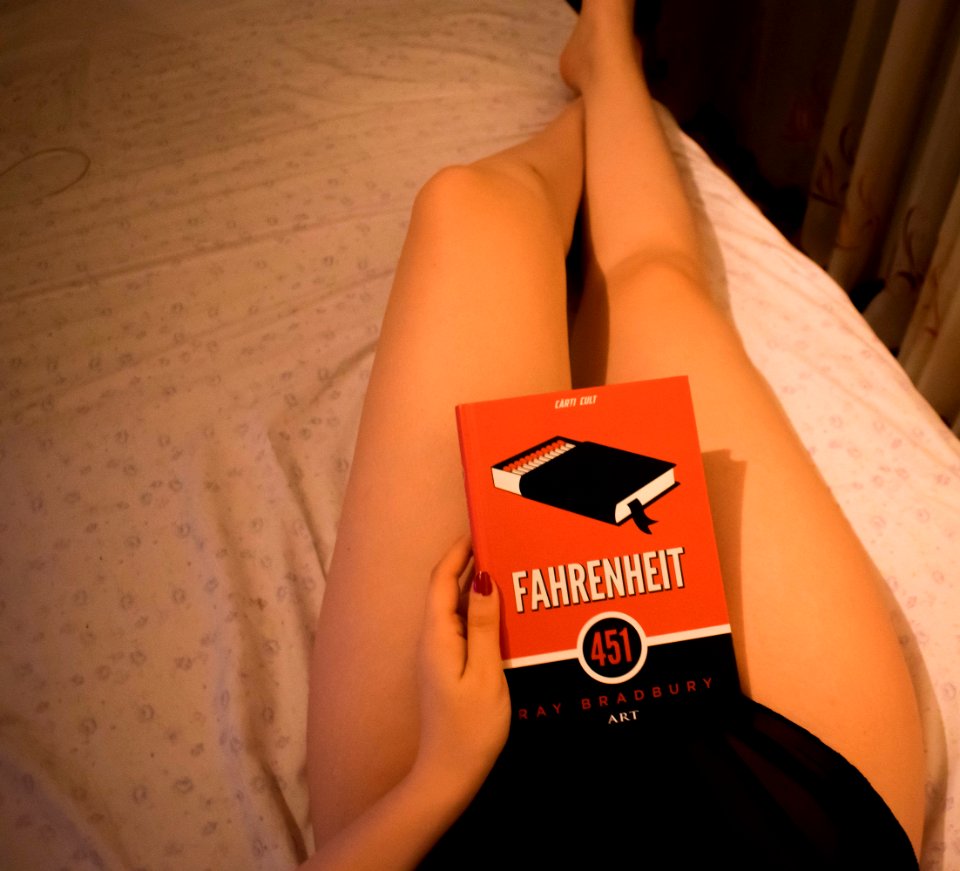 Person Lying On Bed Holding Fahrenheit Box