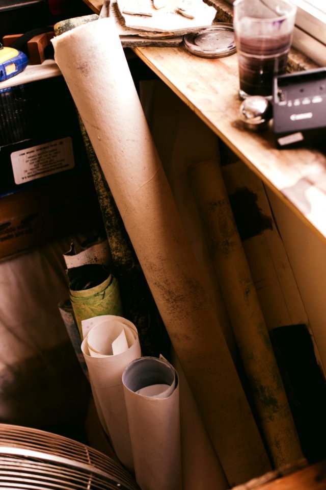 Assorted-color Paper Rolls Beside Wooden Shelf