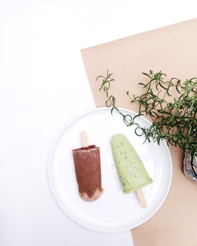 Two Assorted-flavor Ice Pop On Top Of White Plate