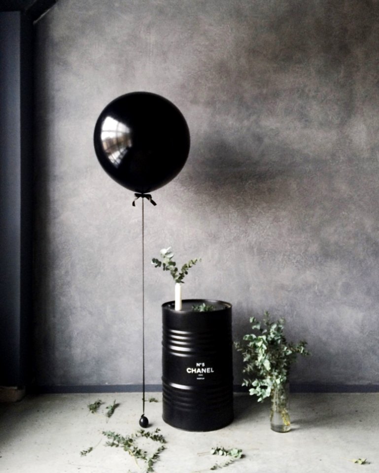 Grayscale Photography Of Balloon Beside Chanel Metal Barrel