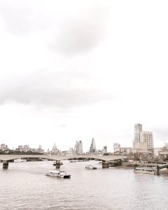 Grayscale Photo Of Bridge Near White Boat photo