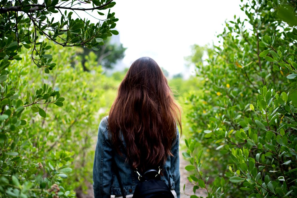 Woman In Gray Denim Jacket In The Middle Of Bushes