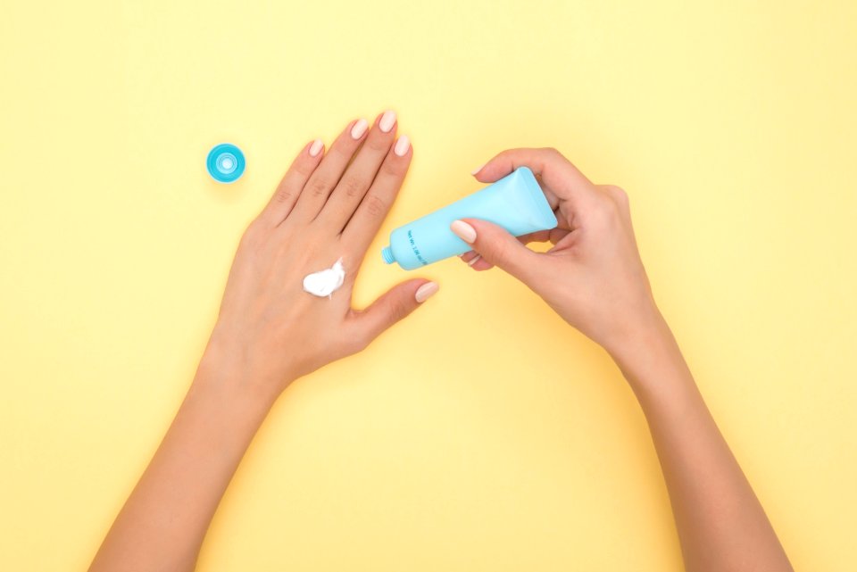 Person Pouring Plastic Tube Bottle