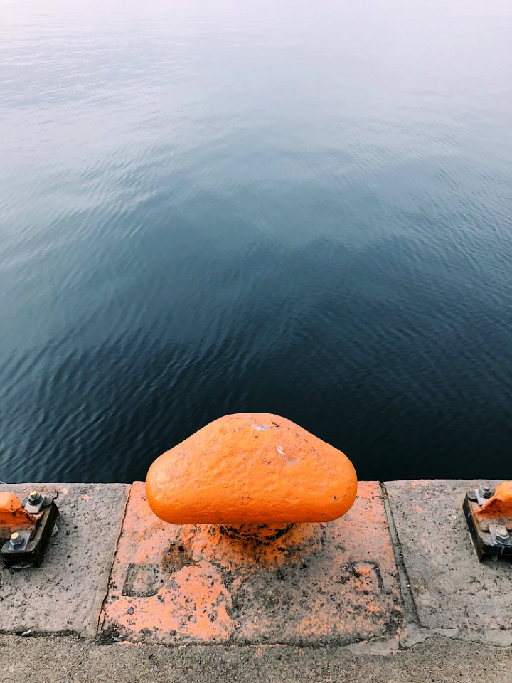 Orange And Gray Concrete Rope Tie Holder At Daytime