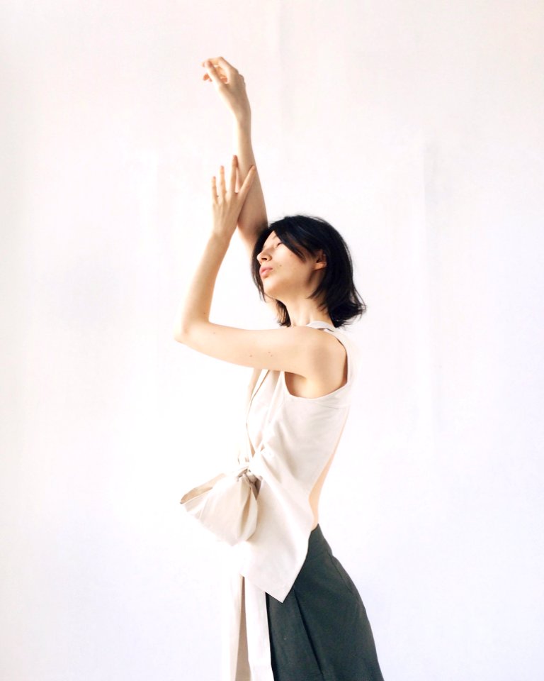 Womens Beige Sleeveless Blouse Raising Hands