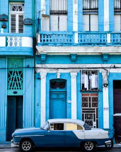 Classic Blue And White Sedan Near Building photo