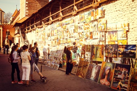 People Looking At Assorted-type Paintings photo